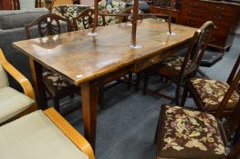A 19th century French fruit wood farmhouse table with a small drawer to one side.