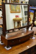 A George III mahogany bow fronted dressing table mirror.