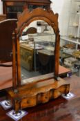 A good George II style walnut dressing table with three drawers to the serpentine fronted base.