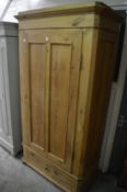 A Continental pine single door armoire.