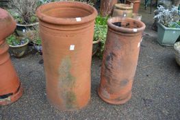Two terracotta chimney pots.