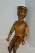 A carved wooden articulated model of a man.