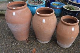 Graduated set of three terracotta pots.