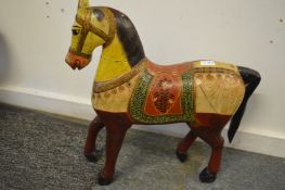 A carved and painted model of a horse.