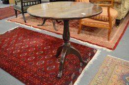 A 19th century oak tilt-top circular tripod table.