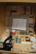 A students microscope, boxed with accessories.