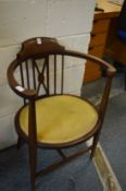 An Edwardian mahogany elbow chair.