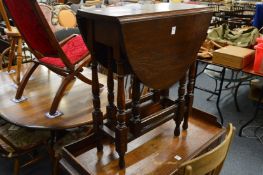 A small oak drop-leaf gateleg dining table.