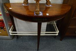 A mahogany demi-lune table.