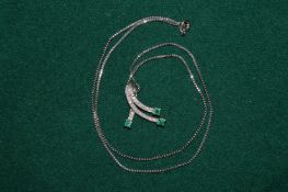 A decorative pendant and chain, diamonds and emeralds, the chain stamped 14K.