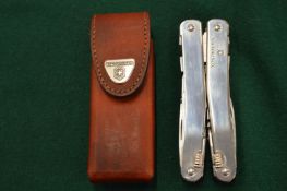A Victorinox multi-tool with leather case.