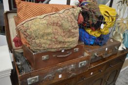 A large quantity of decorative textiles housed in leather suitcases etc.