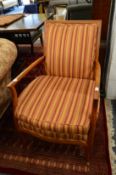 A good pair of walnut framed open armchairs with striped upholstery.