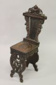 A 19TH CENTURY CONTINENTAL CARVED WALNUT HALL SEAT. 100cms high.