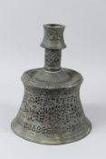 AN EARLY ISLAMIC, POSSIBLY PERSIAN, OPEN WORKED BRONZE CANDLESTICK. 28cms high.