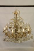 A GOOD PAIR OF ORMOLU CHANDELIERS, with twelve scrolling branches with cut glass pans, the body with