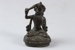 A SMALL CAST BRONZE SEATED TIBETAN / CHINESE BUDDHA. 12cms high.