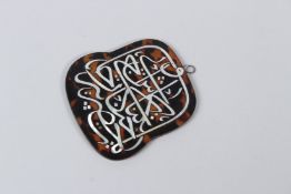 A SUFI ISLAMIC CALLIGRAPHY INLAID TORTOISESHELL PENDANT. 8.5cms x 8cms.