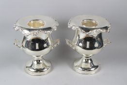 A GOOD PAIR OF PLATED URN SHAPED TWIN HANDLE WINE COOLERS. 32cms high.