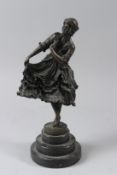 AFTER COLINET. A SMALL BRONZE OF A STANDING FEMALE FIGURE, mounted on a stepped circular marble