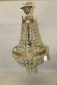 AN ORMOLU AND CUT GLASS CHANDELIER, with swags and prism drops. 60cms long x 30cms wide.