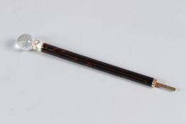 A RUSSIAN TORTOISESHELL PARASOL HANDLE, with cut glass finial and gold mounted enamel collar. 25.