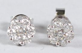 A PAIR OF 18CT WHITE GOLD AND DIAMOND CLUSTER EAR STUDS.