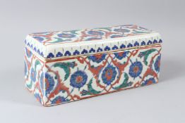 AN OTTOMAN TURKISH IZNIK POTTRY PEN BOX, painted in blue, green and red, with stylised flowerhead
