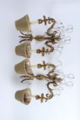 A PAIR OF ORMOLU TWIN-BRANCH WALL APPLIQUES, with cut glass pear shape drops, complete with
