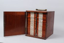 R. & J. BECK, LONDON, A MAHOGANY TABLE TOP SINGLE DOOR CABINET, containing 21 numbered drawers of