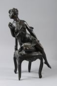 A BRONZE GROUP, semi-nude female figure seated on a chair, foundry mark to reverse. 40cms high.