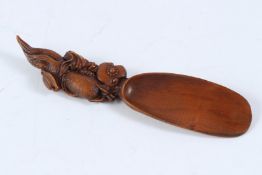 A JAPANESE CARVED WOOD SPOON. 18cms long.