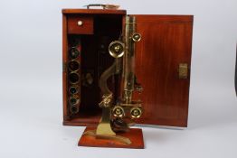 E. WHEELER, LONDON, A 19TH CENTURY BRASS BINOCULAR MICROSCOPE, in a fitted mahogany case, with