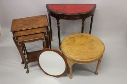 A WALNUT NEST OF TABLES; together with a demi-lune hall table, walnut circular coffee table and a