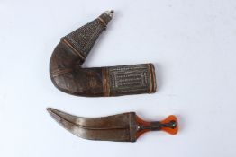 A LARGE 19TH CENTURY ARAB YEMENI JAMBIYA DAGGER with Bakelite handle and silver mounts. 36cms long.