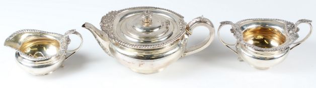 A GOOD SILVER THREE PIECE TEA SERVICE, of rounded, squat shape, each piece with ornate cast