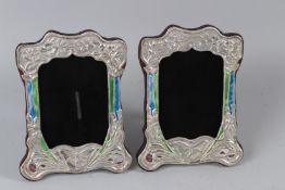 A PAIR OF SILVER AND ENAMEL PHOTO FRAMES.