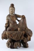 A LARGE CARVED WOOD AND POLYCHROME PAINTED SEATED FIGURE OF GUANYIN, late Ming Dynasty, seated on