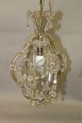 A VENETIAN STYLE CUT GLASS CHANDELIER, with clear and amber coloured prism drops. 70cms long x 34cms