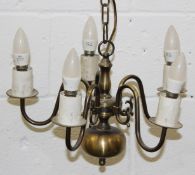 A DUTCH STYLE PATINATED BRASS FIVE-BRANCH CHANDELIER. 42cms diameter.