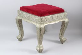 AN INDIAN WHITE METAL MOUNTED STOOL. 44cms x 44cms x 44cms.