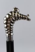 A WALKING STICK, the handle modelled as the Michelin Man. 98cms long.