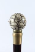 A WALKING STICK WITH BONE GLOBE AND COMPASS HANDLE. 92cms long.