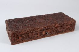 A 19TH CENTURY ANGLO INDIAN CARVED SANDALWOOD BOX. 30cms x 12cms.