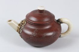 A CHINESE YIXING TEAPOT, mounted jade handle and pipe. 10cms diameter.