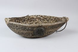 A LARGE CARVED STONE PERSIAN KASHKUL BEGGARS BOWL. 40cms long.