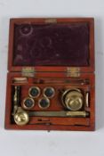 A LATE 19TH CENTURY BRASS BOTANIST OR TRAVELLING MICROSCOPE, in a mahogany case.