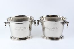 A PAIR OF POLISHED METAL OVAL WINE COOLERS WITH RING HANDLES. 39cms wide.