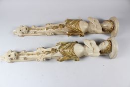 A PAIR OF PAINTED AND PARCEL GILDED PLASTER FEMALE CARYATID FIGURES OR TERMS (faults). 75cms high.