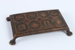 A RARE 18TH CENTURY TIBETAN OR INDIAN JAIN BRONZE SYMBOLS FOOTED PANEL. 16cms x 8cms.